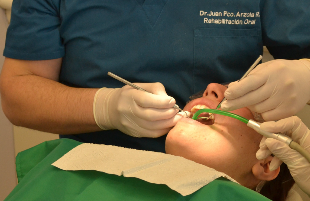 image shows dentist working on patient